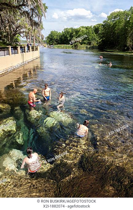 Man and children swim and play at Salt Springs Recreation Area in the Ocala National Forest, Florida