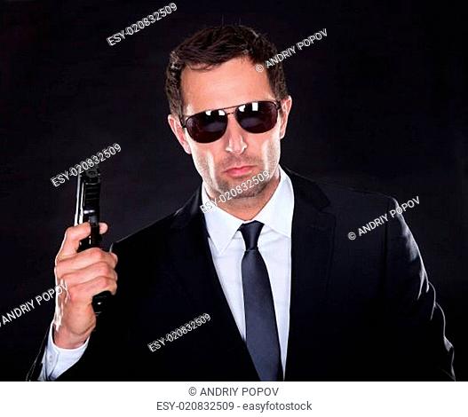 Portrait Of Young Man With Gun