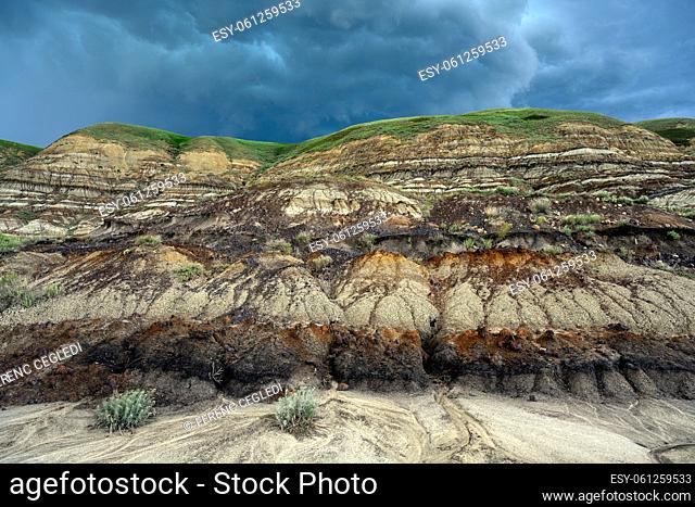 Stormy clouds over the landscape of the Canadian Badlands of Drumheller, the dinosaur capital of the world in Red Deer River Valley, Alberta, Canada