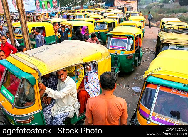 Local people sitting in a tuk-tuk at Kinari Bazaar in Agra, Uttar Pradesh, India. Agra is one of the most populous cities in Uttar Pradesh