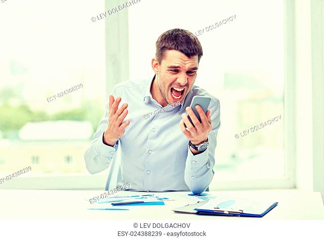 business, people, stress and technology concept - close up of angry businessman with smartphone shouting