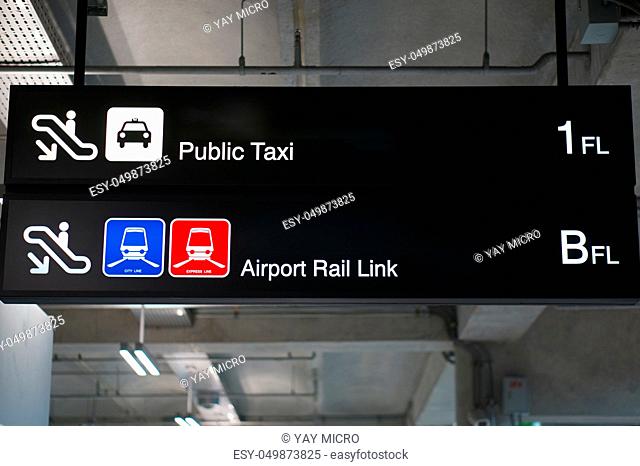Public taxi and Airport rail link information board sign with white character on black background at international airport terminal