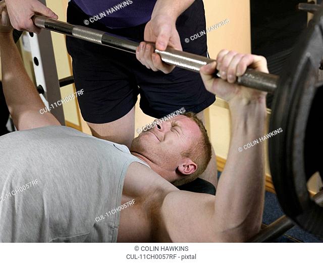 man exercising with weights at gym