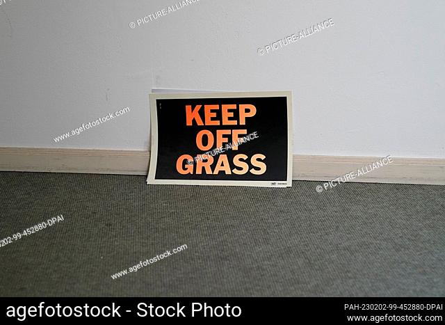 02 February 2023, Schleswig-Holstein, Lübeck: ""Keep off Grass"" is written on a note in the stairwell at the Günter Grass House