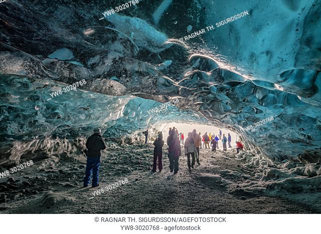 Tourists in The Crystal Cave, Breidamerkurjokull Glacier, Iceland. Emerald Blue Ice and Ash is part of Breidamerkurjokull