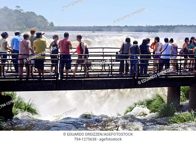 Tourists at the Devil's throat waterfall platform, Iguazu National Park, Argentina
