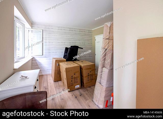 construction site, redevelopment and renovation of an apartment, packed furniture and moving boxes in an empty room