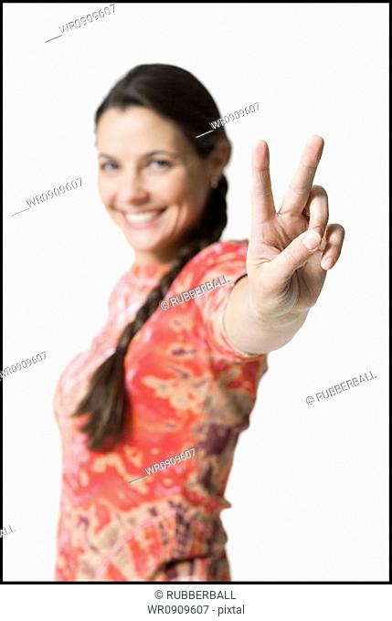 Woman making peace gesture