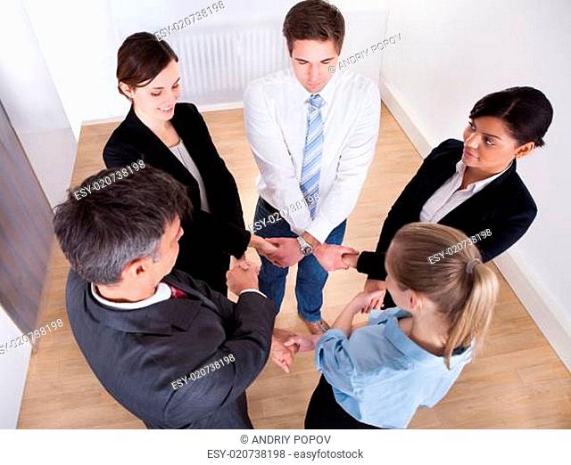 Group Of Businesspeople Holding Hands