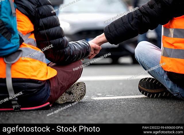 22 February 2023, North Rhine-Westphalia, Dortmund: Climate activists from the group Last Generation taped their hands together to block a major highway