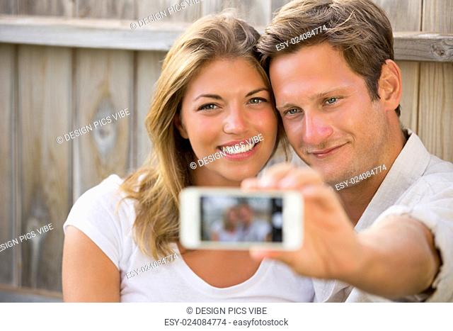 Happy young couple taking a selfie with smart phone
