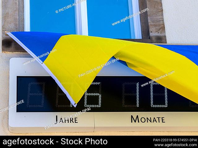 18 March 2022, North Rhine-Westphalia, Minden: The flag of Ukraine flies over the European Peace Clock in Minden, which indicates 76 years and 10 months of...