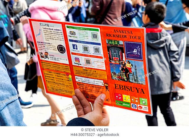 Japan, Honshu, Tokyo, Asakusa, Rickshaw Puller Holding Rickshaw Tour Advertising Pamphlet