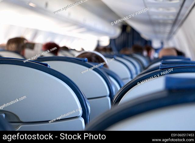 The passenger compartment of a small airplane. A lot of empty seats