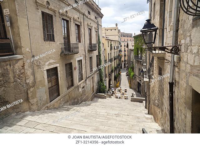 Street view, ancient buildings, stone stairs, historic center, Pujada de Sant Domenec or Escalinata de Sant Marti, Girona, Catalonia. Spain