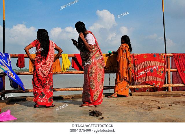 After bathing in the holly Ganges River women drying sally and combing hair