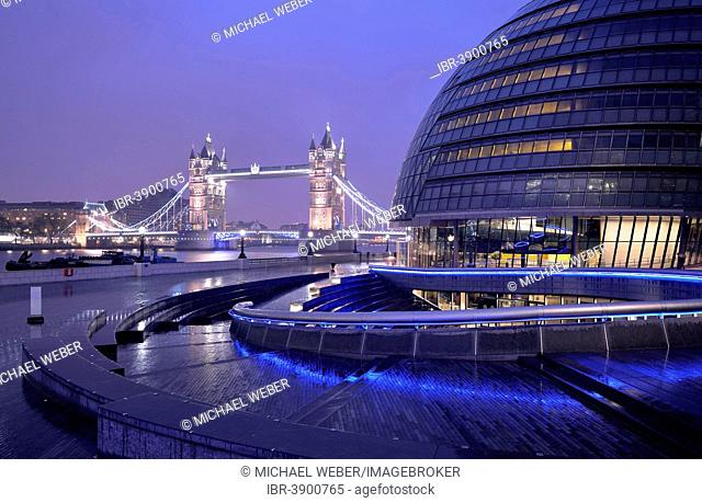 City Hall designed by Sir Norman Foster, Tower Bridge at the back, at dusk, London, England, United Kingdom