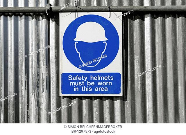 Safety helmets must be worn in this area, sign on a construction site