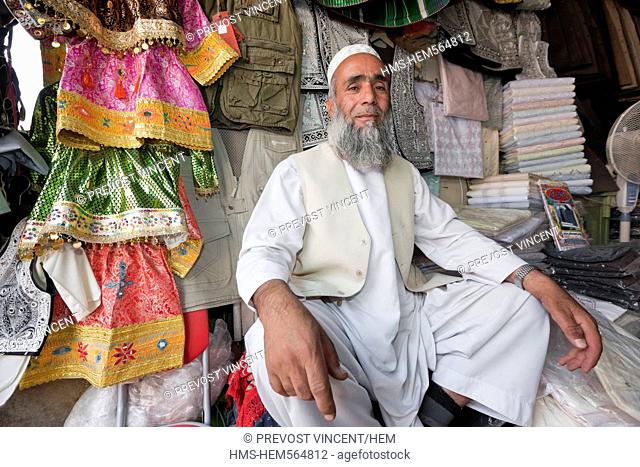 Afghanistan, Kabul, Chahari Sadarat, proud clothes seller