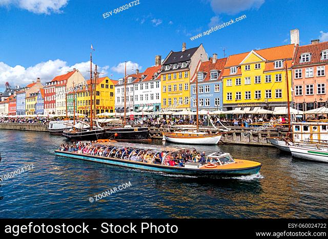 Copenhagen, Denmark - August 21, 2019: Famous Nyhavn district in the city centre with colorful houses