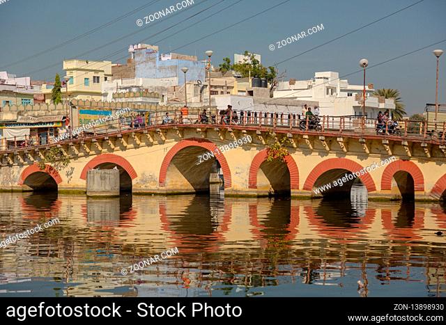 UDAIPUR, INDIA - NOVEMBER 24, 2012: Pichola lake and old bridge in Udaipur, India