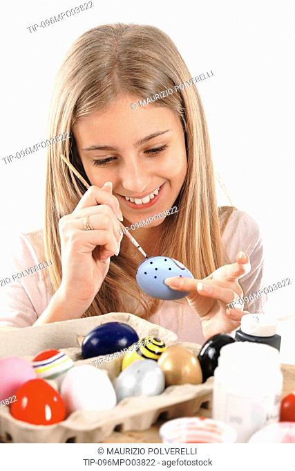 Girl painting Easter eggs