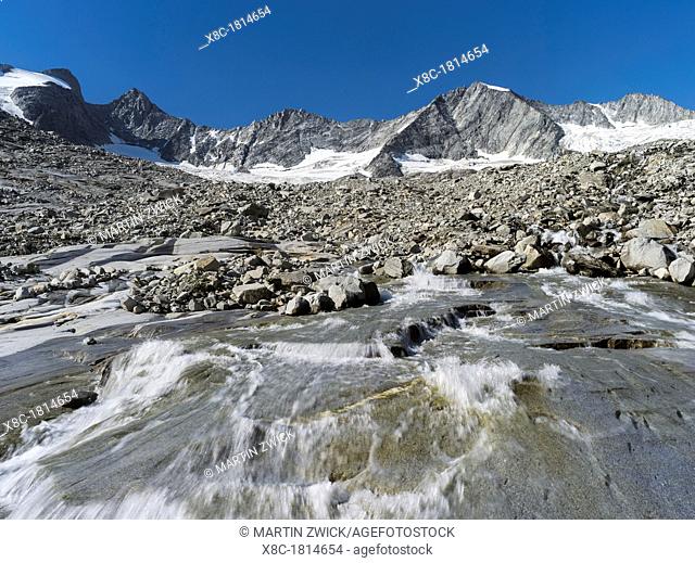 The Reichenspitz Mountain Range in the Zillertal Alps in the National Park Hohe Tauern  Glacial torrent of the glacier Wildgerlos Kees , Mount Gabler
