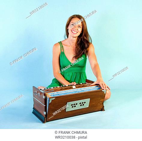 Woman Playing Harmonium Musical Instrument Smiling