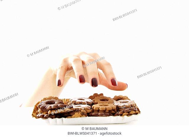female hand from under the table grabbing at cookies