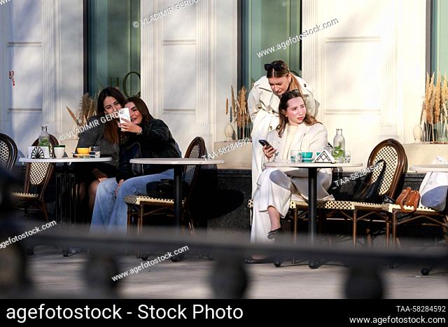 RUSSIA, MOSCOW - APRIL 7, 2023: Women sit in a pavement cafe in Tverskoy Boulevard. Vladimir Gerdo/TASS