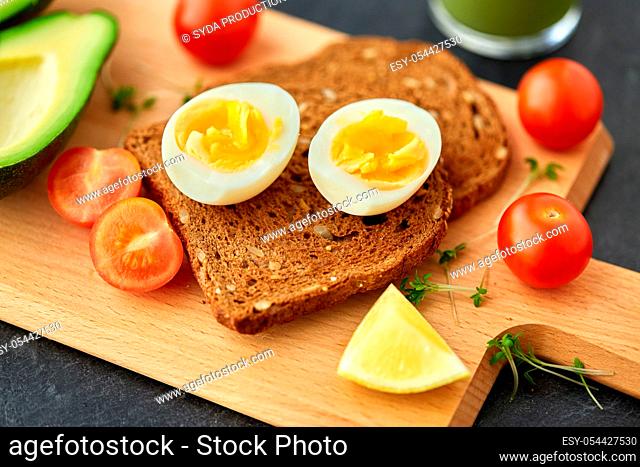 toast bread with eggs, cherry tomatoes and avocado