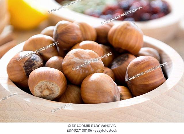 Hazelnuts in wooden bowl ready to be cracked and eaten