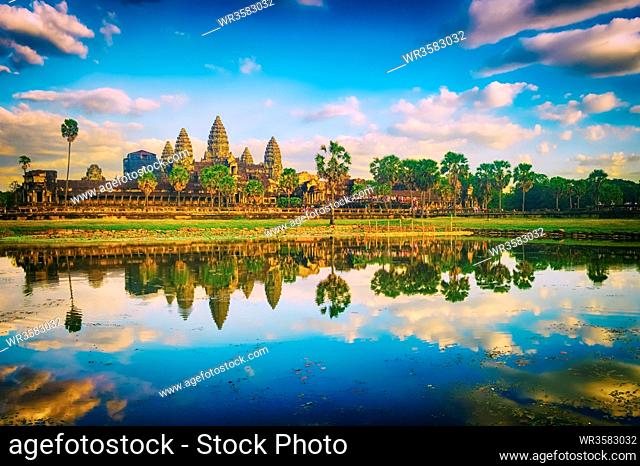Angkor Wat temple reflecting in water of Lotus pond at sunset. Siem Reap. Cambodia. Panorama