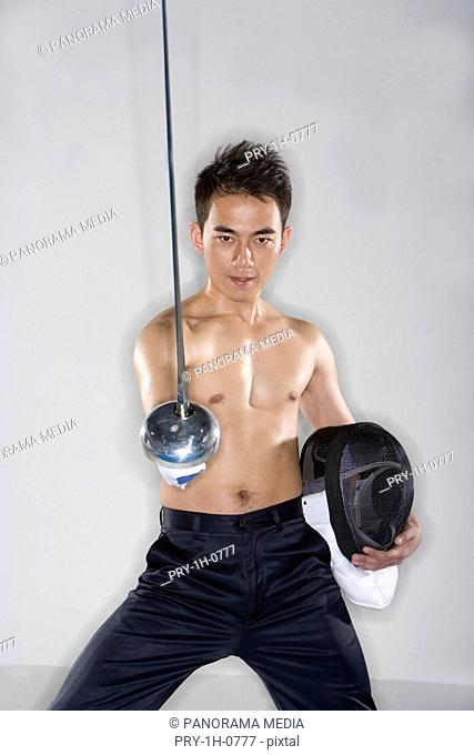 a man bare from the waist upward practicing himself in fencing