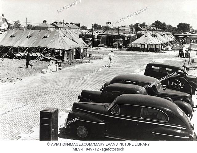 Cars Parked and Tents Used As Terminal Buildings with a Boac Sign