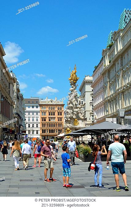 People in the traditional pedestrian zone Graben the Austrian capital Vienna with view of the Plague column - Austria
