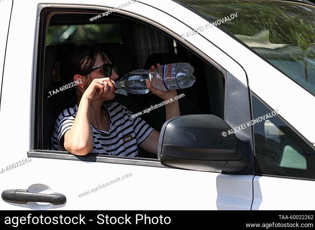 RUSSIA, KHERSON REGION - JUNE 23, 2023: A woman passenger queues to pass the Armyansk checkpoint between the Kherson Region and Crimea