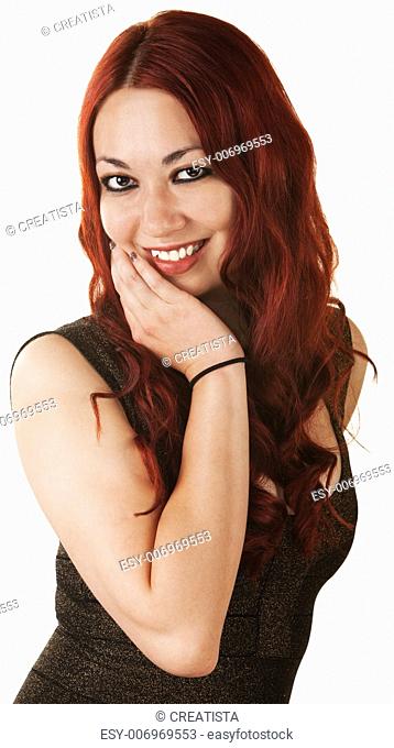 Cute cheerful Hispanic woman with hand on chin