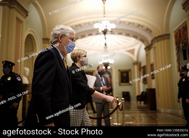 Senate Minority Leader Mitch McConnell, a Republican from Kentucky, wears a protective mask while walking through the U.S. Capitol in Washington, D.C