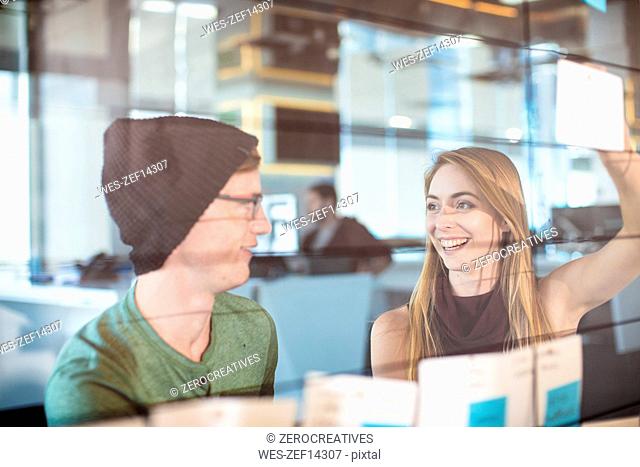 Young man and woman working together in an office