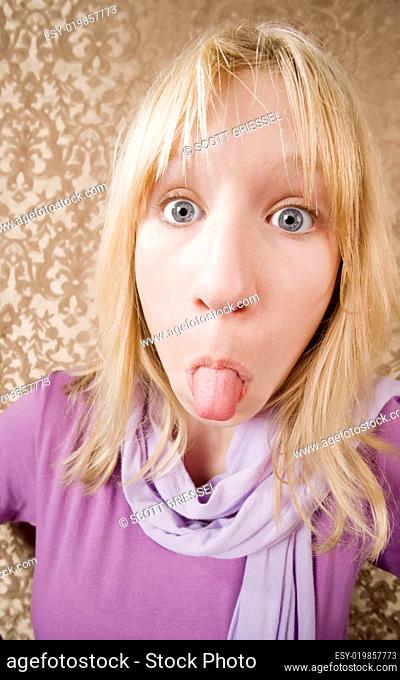 Young girl sticking out her tongue
