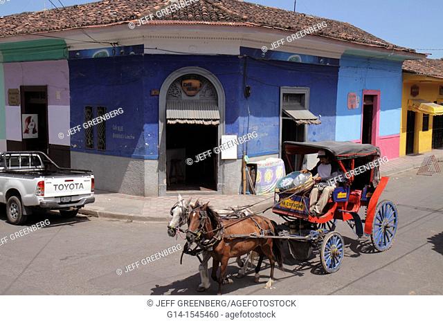 Nicaragua, Granada, Calle Vega, colonial heritage, neighborhood, street scene, corner, building, business, colorful, roof tiles, horse drawn carriage