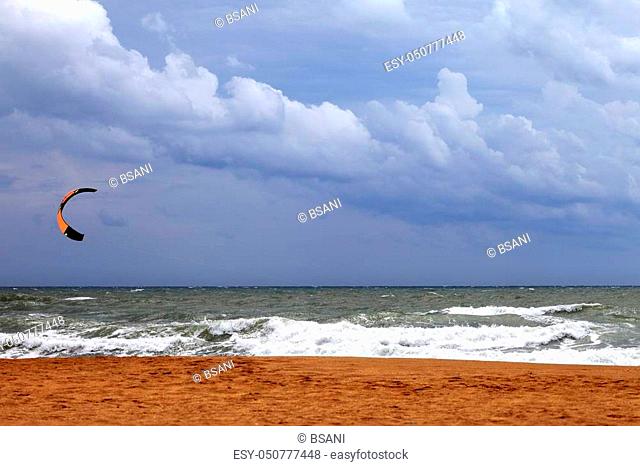 Power kite in sea and cloudy sky before rain