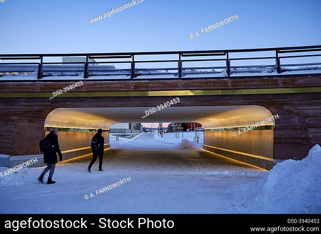 Sundsvall, Sweden Pedestrians in the evening light in a snowy downtown in winter in a passage