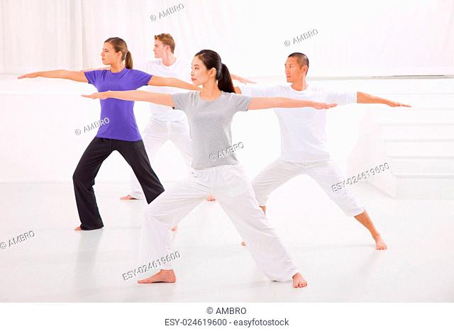 Sporty people stretching hands yoga class in fitness studio