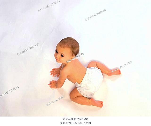 High angle view of a baby crawling on the floor