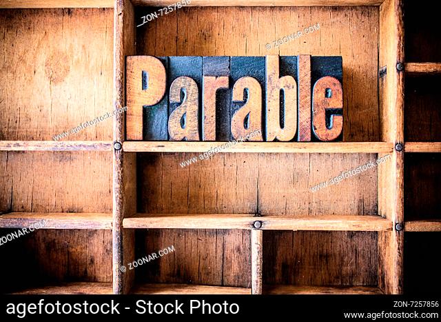 The word PARABLE written in vintage wooden letterpress type in a wooden type drawer