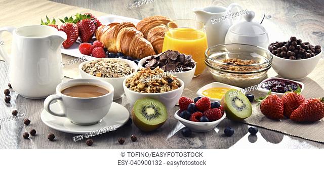 Breakfast served with coffee, orange juice, croissants, cereals and fruits. Balanced diet