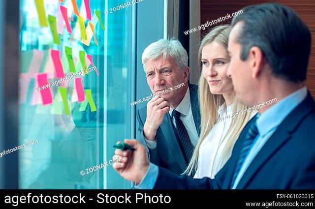 Business people brainstorming ideas. Entrepreneurs having a standing meeting discussing ideas strategy planning problem solution concept