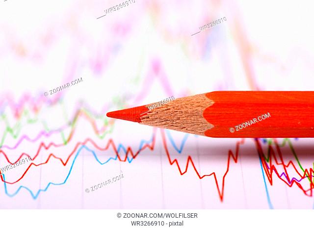 financial chart and pencil shows success at stock market